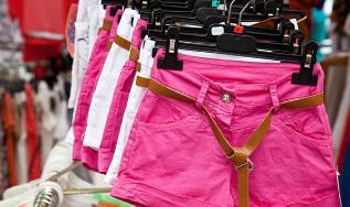Some pink shorts hanging in a row