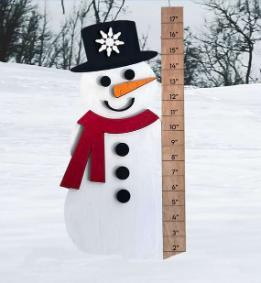 A snowman next to a ruler