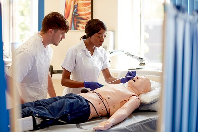 Student administering treatment on sim mannequin